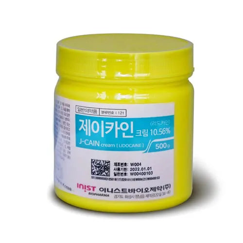 Yellow jar of J-CAIN 10.56% cream lidocaine 500g with Korean text on a white background