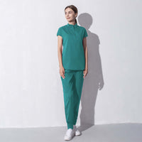 Female model wearing green fashion women salon workwear, designed for beauty aesthetics, showcasing style, comfort, and professionalism.