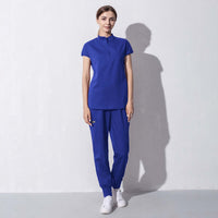 Fashionable blue salon workwear for women, merging style, comfort, and professionalism for beauty and aesthetics professionals.