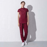 Fashionable women's salon workwear in maroon, combining beauty and aesthetics for a stylish and professional look.